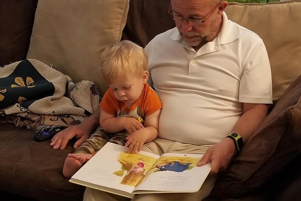 grandfather reading with grandson