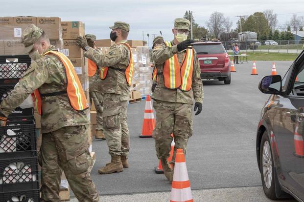 Soldiers from the Vermont Army National Guard assist with distribution of meals.