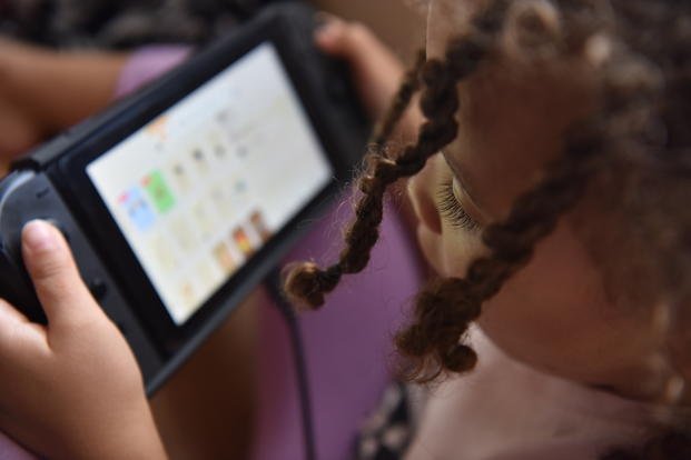 close up of child on gaming device