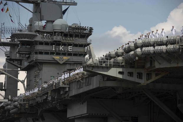 Sailors man the rail as the aircraft carrier Eisenhower returns to Norfolk in August 2020