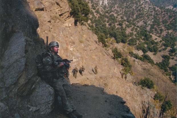 Spc. Kyle J. White rests on a hike