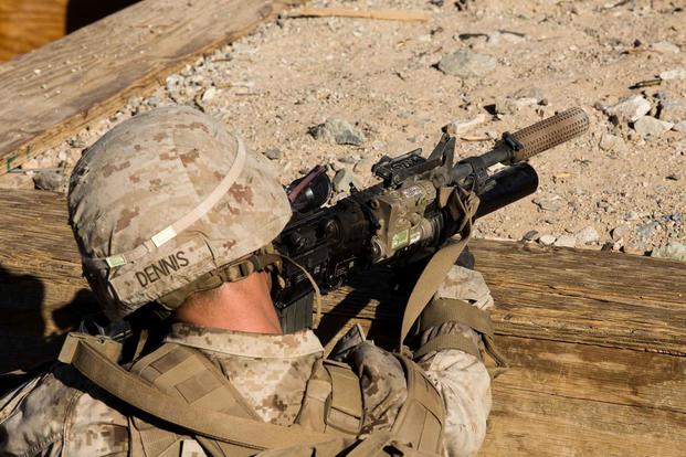 A U.S. Marine utilizes a suppressor.