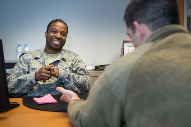 Air Force recruiter  speaks with an active-duty airman about the benefits of the Air Force Reserve.