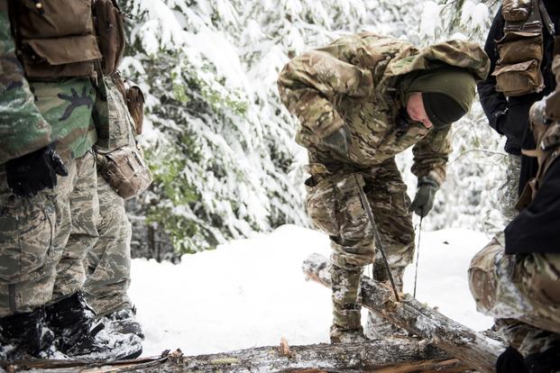 An instructor shows how to prepare firewood at the Air Force Survival School Training Area.