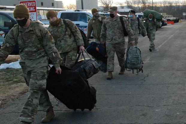 New York Air National Guard Security Forces airmen board buses