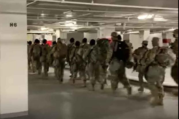 National Guard troops depart a Washington, D.C. parking garage.