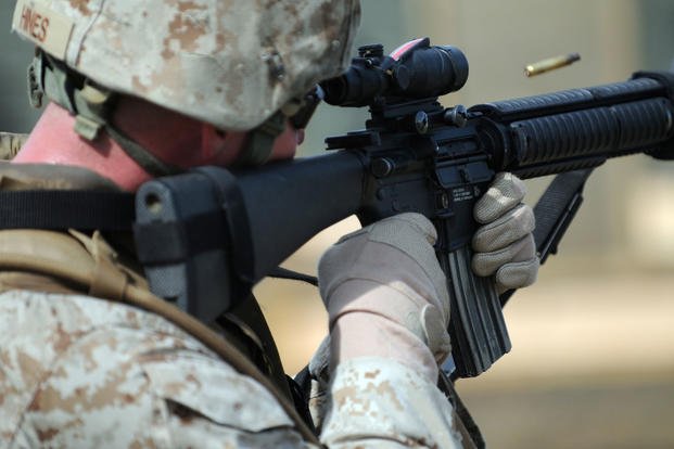 Petty officer 3rd class fires M16 rifle during qualification