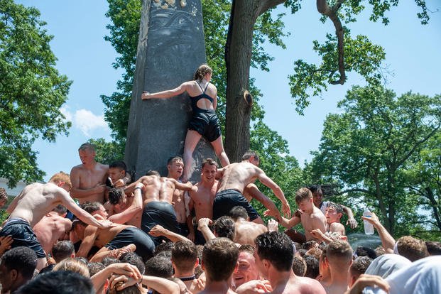 Naval Academy freshmen, or plebes, climb the Herndon Monument, a tradition symbolizing the successful completion of the midshipmen freshman year, May 20, 2019. (Josiah D. Pearce/U.S. Navy) Naval Academy freshmen, or plebes, climb the Herndon Monument