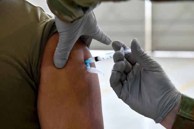 A U.S. airman receives a COVID-19 vaccination at Aviano Air Base.