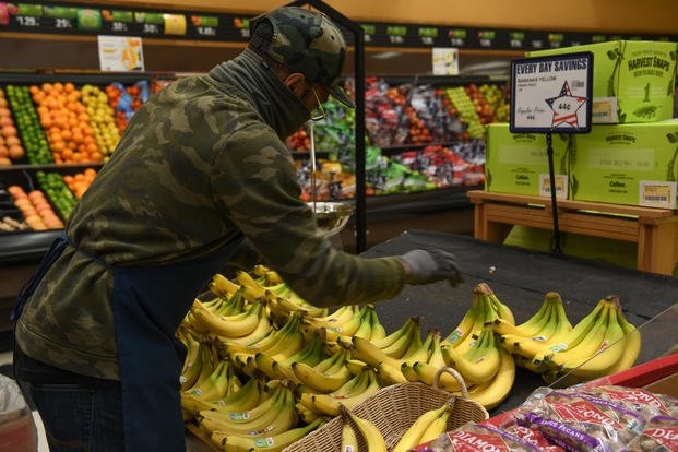 A commissary employee stocks bananas at F.E. Warren AFB