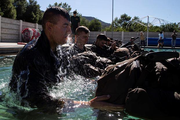 U.S. Marine Pfc. Benjamin Cameron jumps into the pool as part of the Infantry Marine Course.