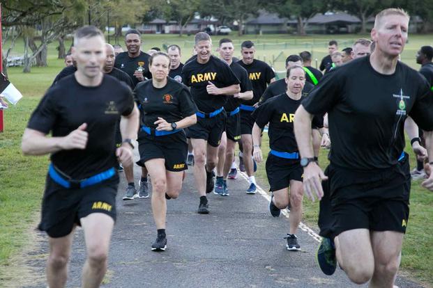 Officers begin the two mile run during an Army Combat Fitness Test.