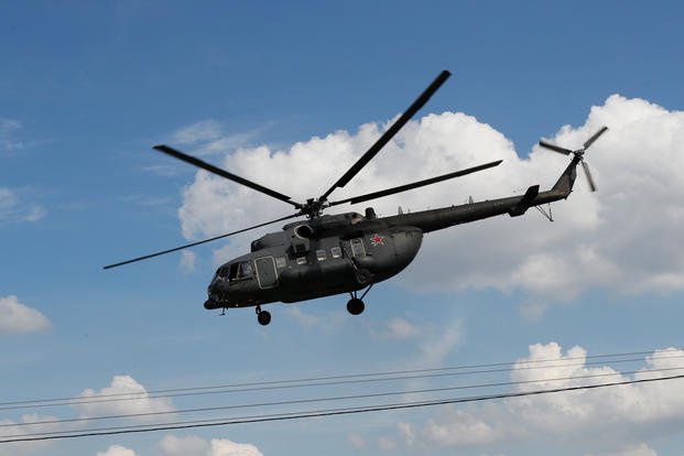 Russian military Mi-8 helicopter flies away from the Defense Ministry headquarters in downtown Moscow