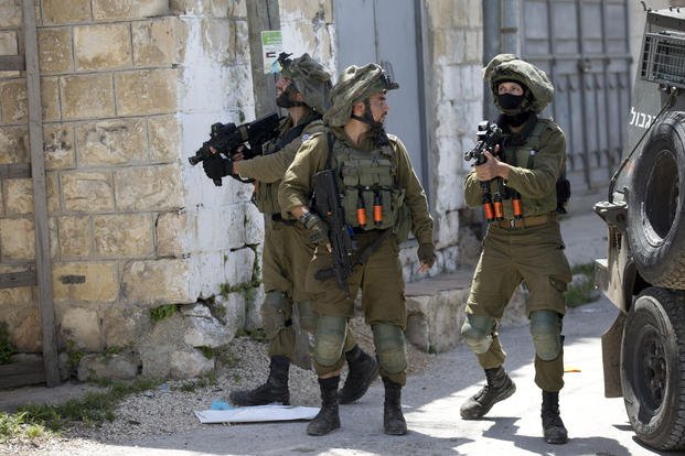 Israeli soldiers patrol after soldier killed