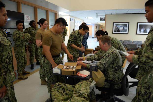 Navy sailors at a monthly urinalysis test.