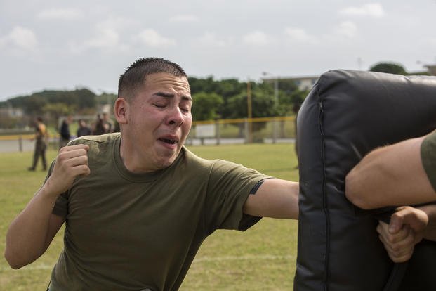 A Marine strikes a punching bag