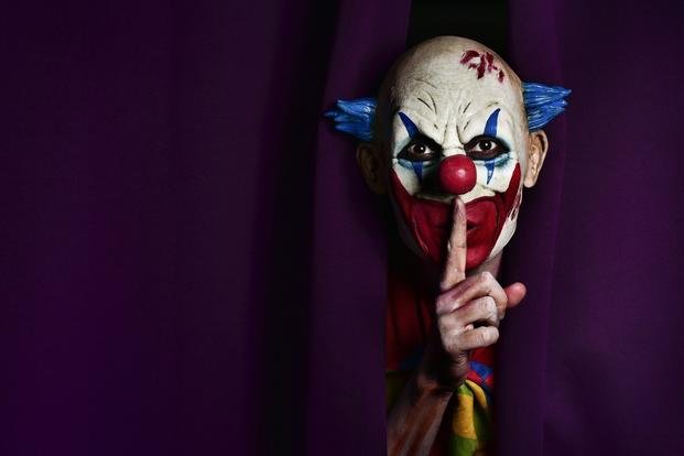scary clown peeks through transition curtain