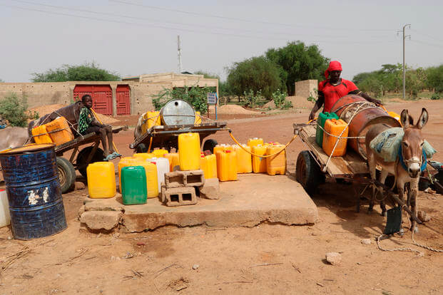 Residents fill up water containers in Dori, Burkina Faso