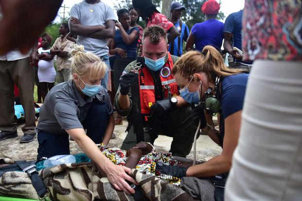 U.S. Coast guard assists an injured female in Haiti.