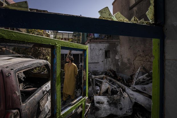 An Afghan inspects the damage of Ahmadi family house in Kabul