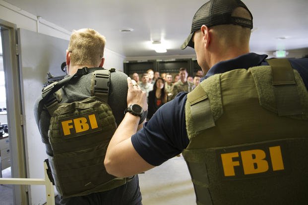 FBI team members demonstrate an execution of a search warrant. 