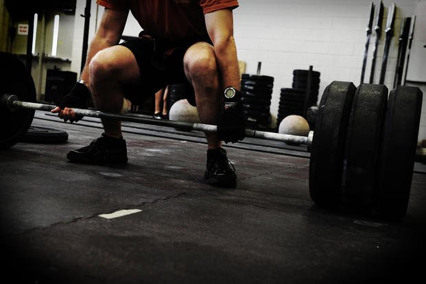 Airman performs deadlift during weightlifting competition.