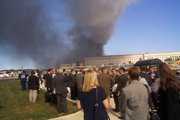 Pentagon employees along with members of the Crane Group gather in the South Parking Lot area following the attack, 11 September 2001