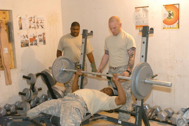 Soldier performs bench press as he tries to attain one of his fitness goals.