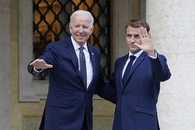 U.S. President Joe Biden, left, and French President Emmanuel Macron wave prior to a meeting at La Villa Bonaparte in Rome.