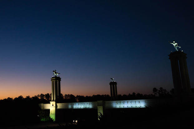 A bridge marks the entrance to the U.S. Army's Fort Benning as the sun rises.