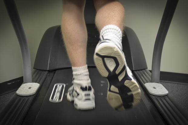 An airman walks on a treadmill.