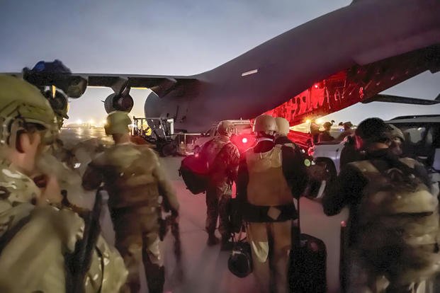 Paratroopers assigned to the 82nd Airborne Division, and others, prepare to board a C-17 cargo plane at Hamid Karzai International Airport in Kabul, Afghanistan.