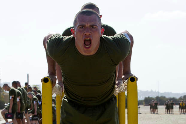 A Marine recruit performs dips.