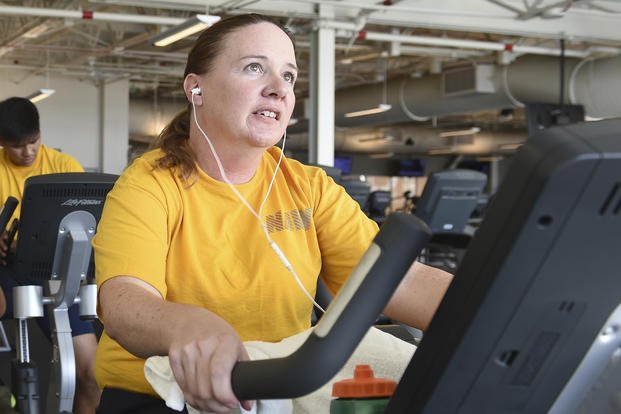 A sailor spins on the stationary bike during a physical fitness assessment.