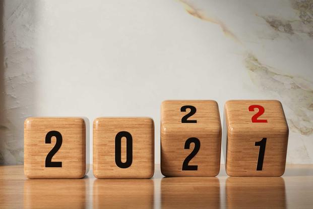 Numbered wood blocks turning over to read "2022"