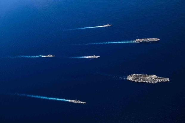 The USS Shiloh, USS Lake Champlain, USS Carl Vinson and USS Milius sail alongside Japanese vessels during bilateral operations in the South China Sea.