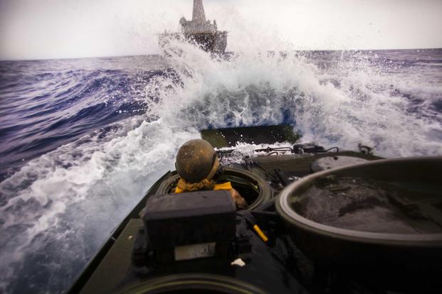 A U.S. Marine drives an assault amphibious vehicle