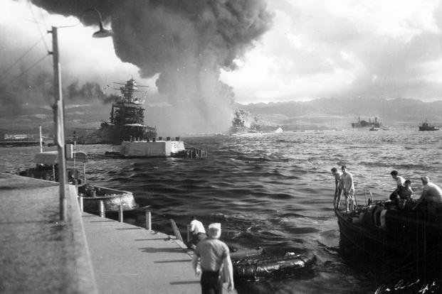 View looking down Battleship Row from Ford Island Naval Air Station, shortly after the Japanese torpedo plane attack. USS California (BB-44) is at left, listing to port after receiving two torpedo hits.