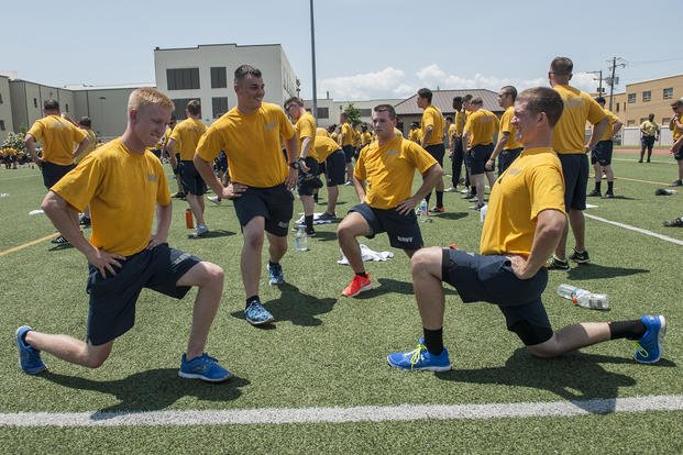 Sailors perform lunges during command physical training. 
