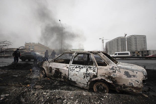 A car, which was burned after clashes, is seen on a street in Almaty, Kazakhstan.