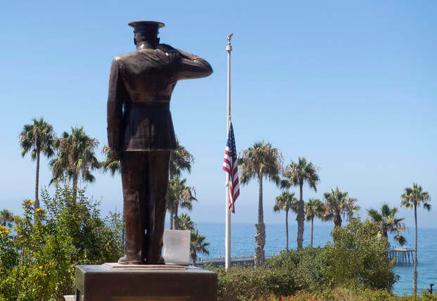 The U.S. flag is seen lowered to half-staff at Park Semper Fi in San Clemente, Calif.