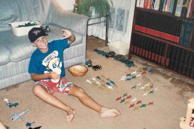 Brian Thompson plays with toy planes while living in Oahu