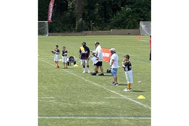 Joshua Plummer, center, coaches his stepson’s sixth-grade flag football team at an NFL Flag Open Tournament in Atlanta in June. (Photo courtesy of Joshua Plummer) Joshua Plummer coaches his stepson’s sixth-grade flag football team