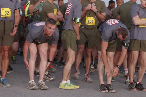 Runners stretch before the 2013 Marine Corps Marathon Forward at Camp Leatherneck, Afghanistan.