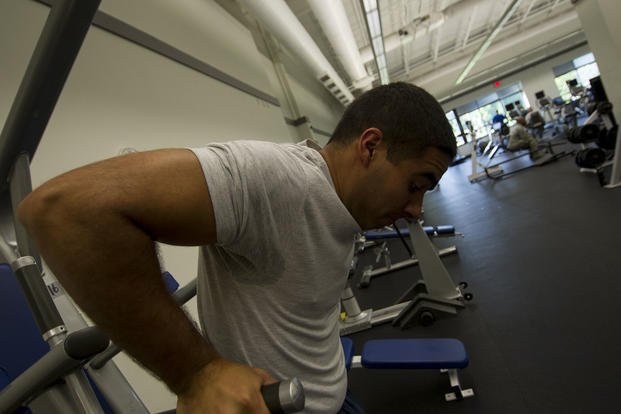 A senior airman completes a set of dips.