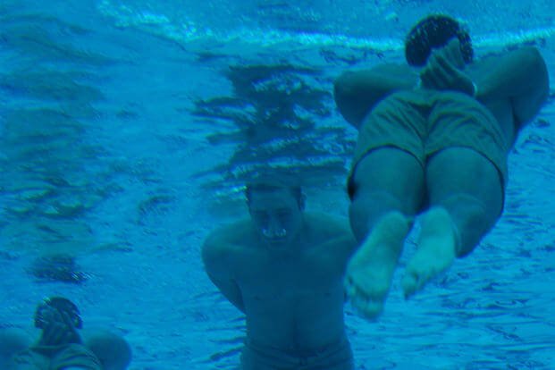 Basic Underwater Demolition/SEALs students swim 100 meters with bound hands and feet as part of their first-phase swimming test.