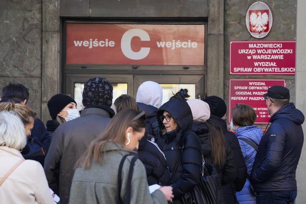 Applicants wait in line at the main passport office in Warsaw.