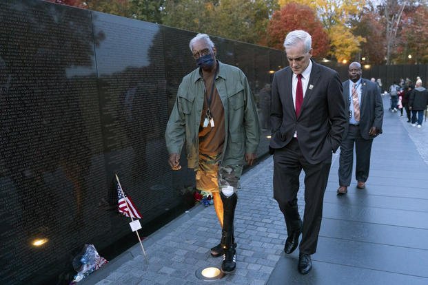 Veterans Affairs Secretary Denis McDonough walks at the Vietnam Veterans Memorial
