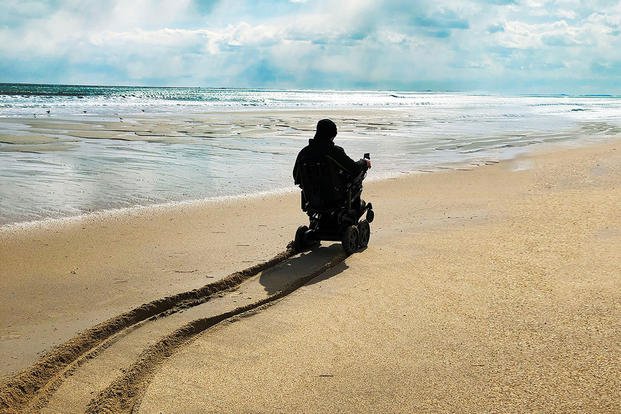 Man on a Beach using the Mobius Mobility Device