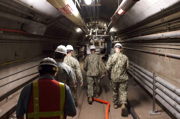 Navy engineers walk through the tunnels of the Red Hill Bulk Fuel Storage Facility.